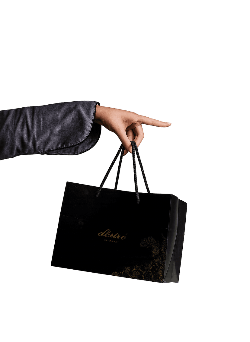 Hand holding black Desire shopping bag